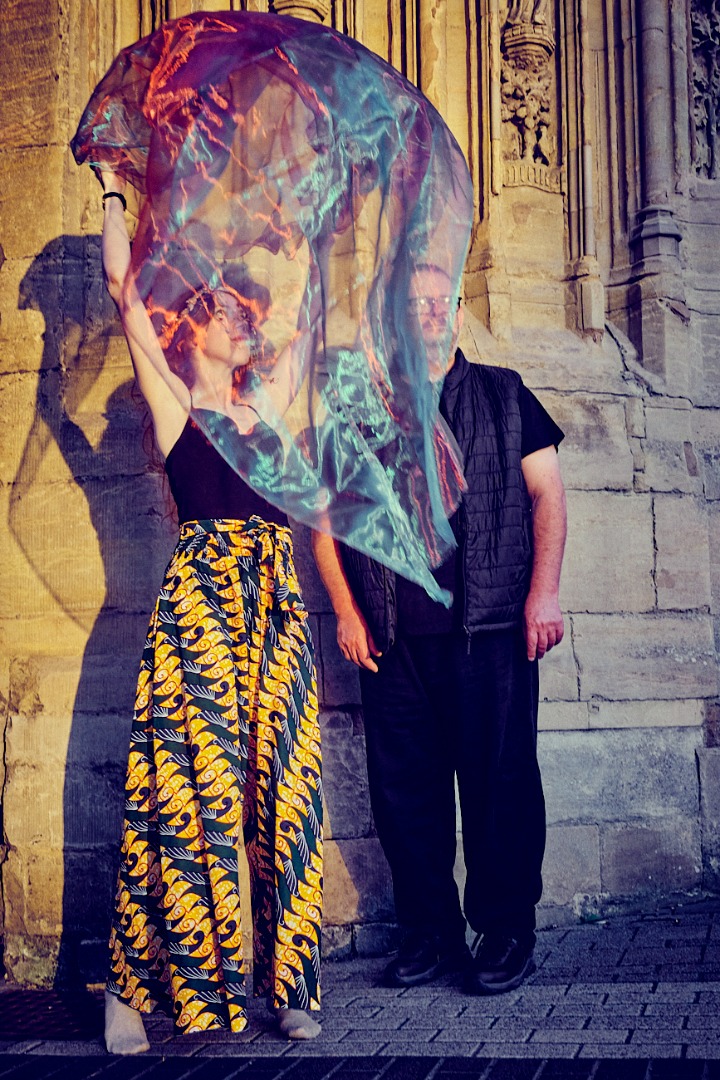 .astriDrift performers moving beneath translucent fabric