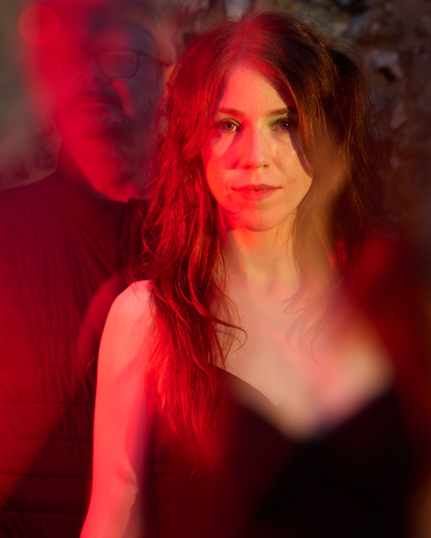 Red-toned double exposure portrait of .astriDrift